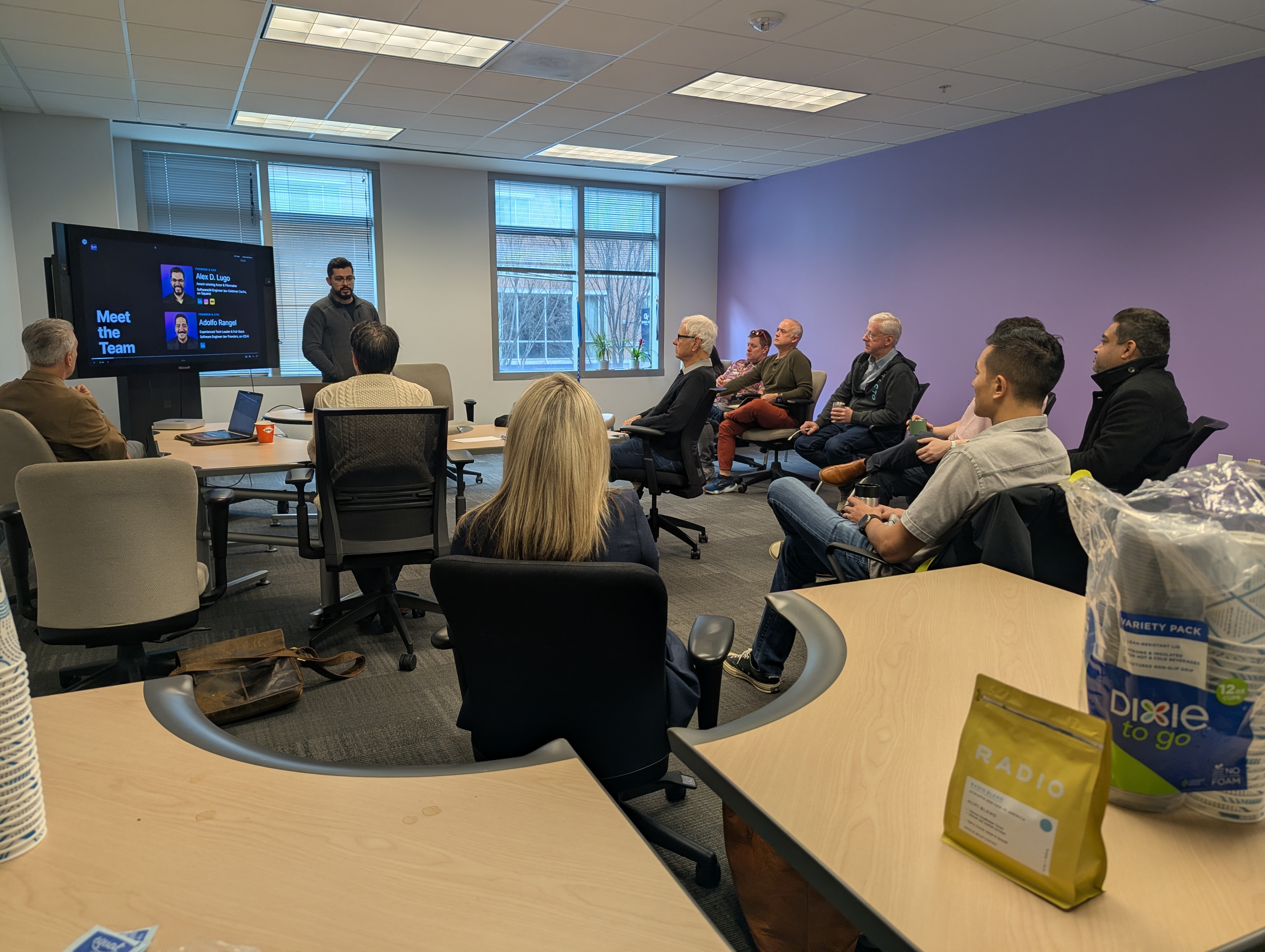 A presenter shares their work with the Mond(AI)y Coffee group at ATDC in Atlanta